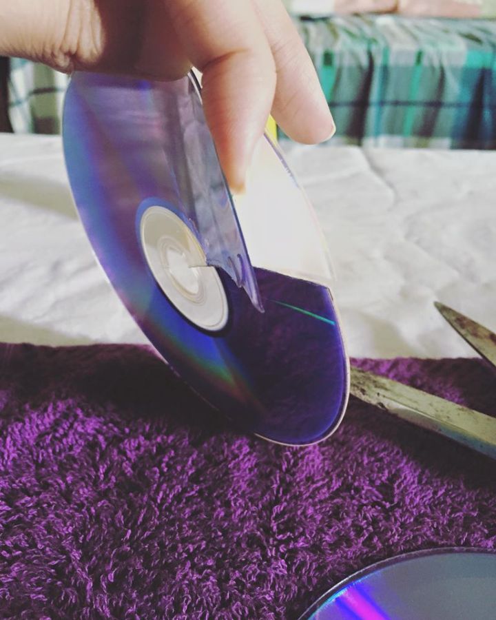 Separate the plastic side of the CD from the shiny side (this is the best way that I can explain it in)